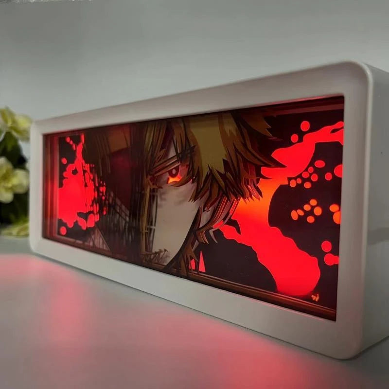 Lampe Décorative Chainsaw Man | Boîte lumineuse avec design en papier découpé représentant le visage de Denji et Pochita. Parfaite pour décorer une chambre ou un bureau, cette lampe offre une ambiance unique pour les fans de manga et d'anime