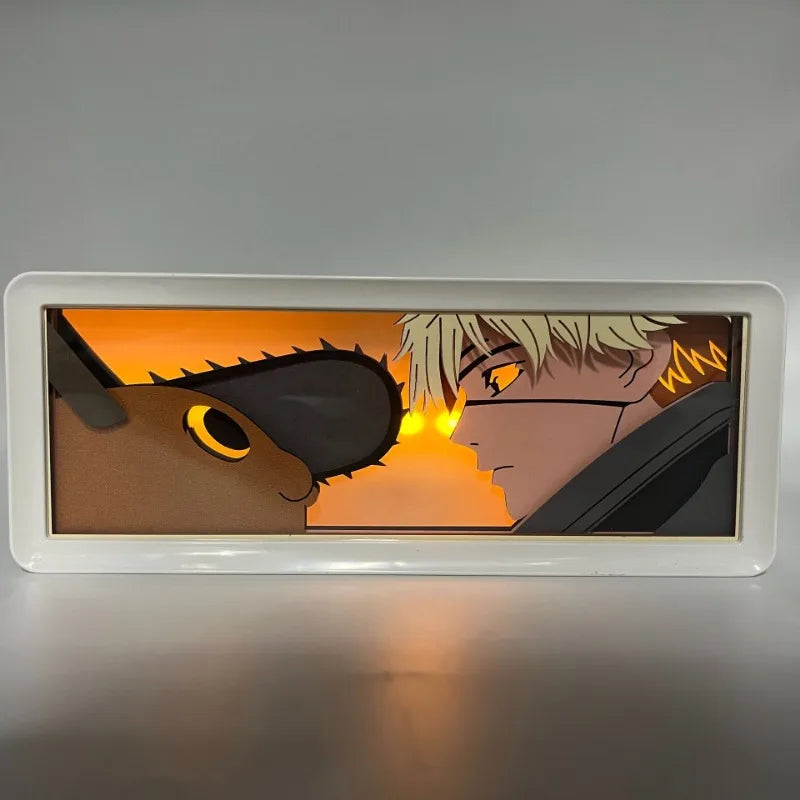 Lampe Décorative Chainsaw Man | Boîte lumineuse avec design en papier découpé représentant le visage de Denji et Pochita. Parfaite pour décorer une chambre ou un bureau, cette lampe offre une ambiance unique pour les fans de manga et d'anime