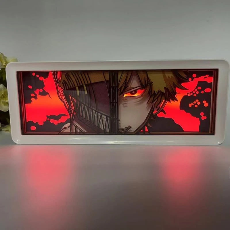 Lampe Décorative Chainsaw Man | Boîte lumineuse avec design en papier découpé représentant le visage de Denji et Pochita. Parfaite pour décorer une chambre ou un bureau, cette lampe offre une ambiance unique pour les fans de manga et d'anime