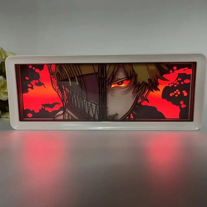 Lampe Décorative Chainsaw Man | Boîte lumineuse avec design en papier découpé représentant le visage de Denji et Pochita. Parfaite pour décorer une chambre ou un bureau, cette lampe offre une ambiance unique pour les fans de manga et d'anime